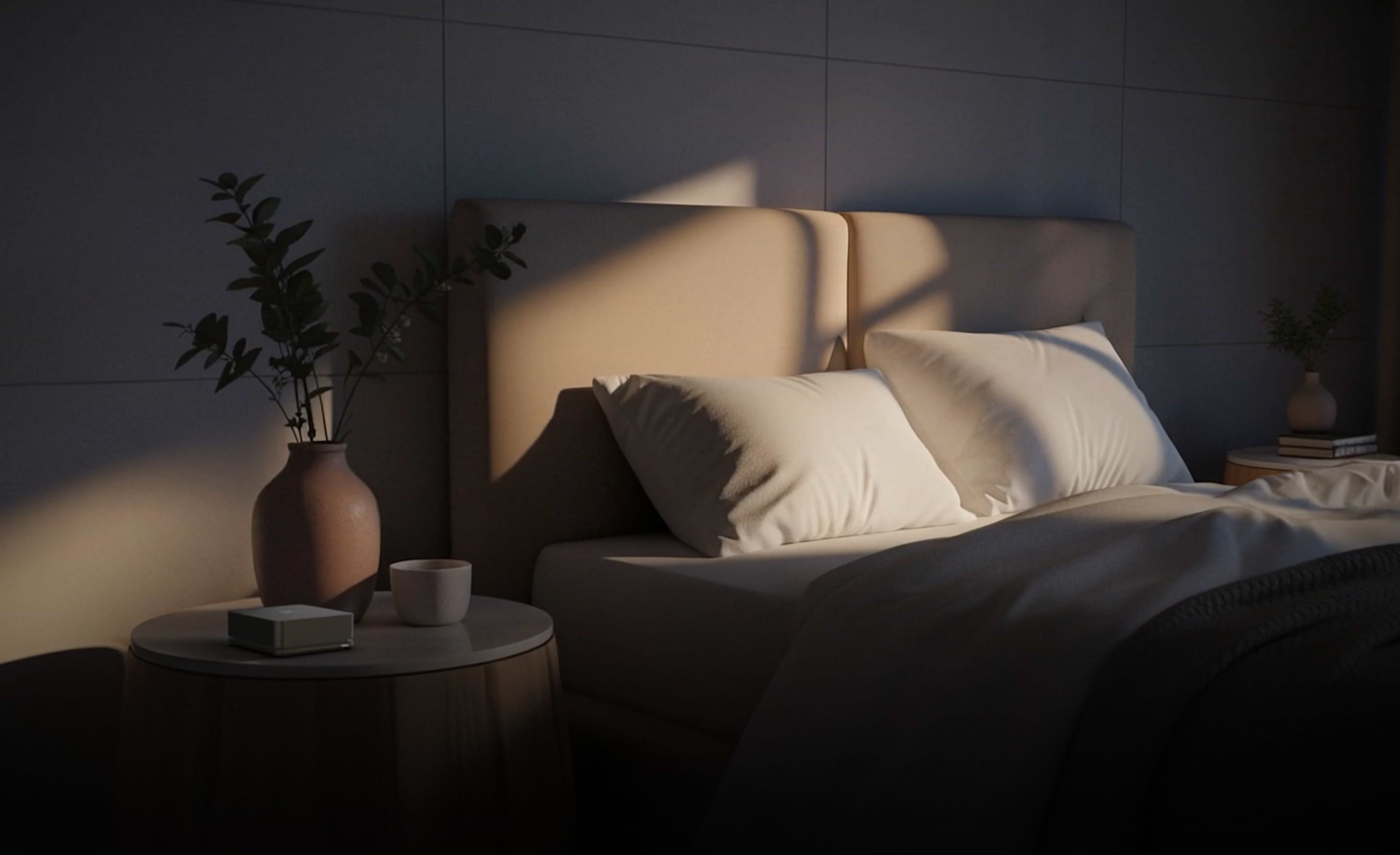 Ultrahuman Home device on dark surface with blurred background of person wearing ring