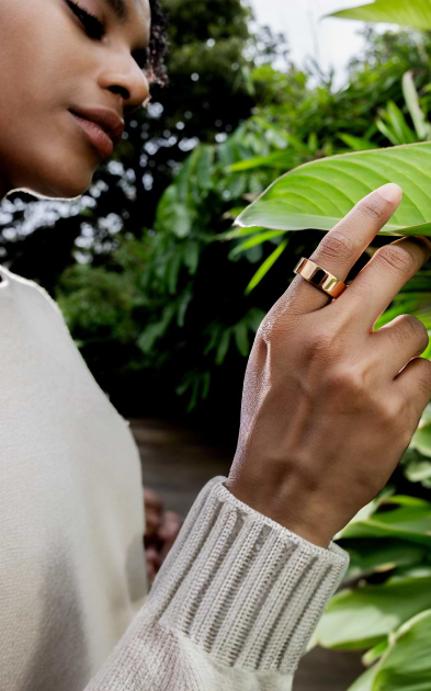 woman touching leaf wearing ultrahuman ring