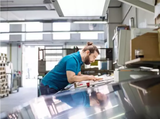 man-working-on-print-machine