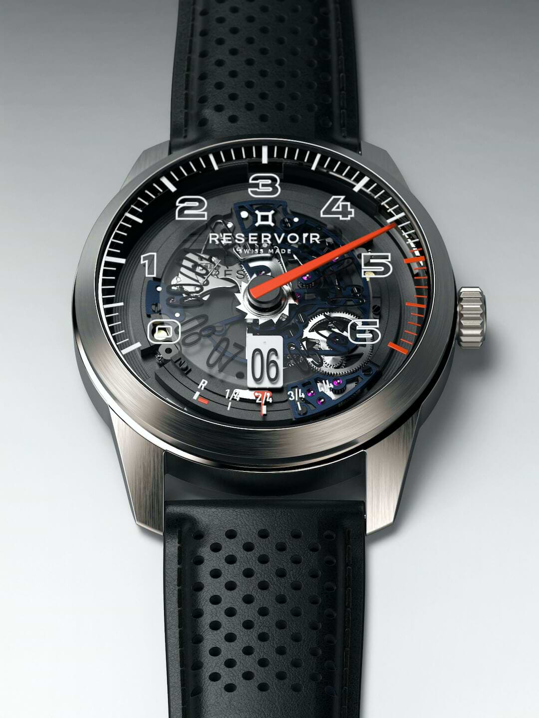 Luxury RESERVOIR watch in media editorial featuring light grey, dark charcoal, and dark greyish brown.