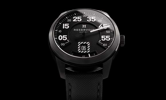 Media showing a luxury RESERVOIR watch with black, light grey and dark grey details.