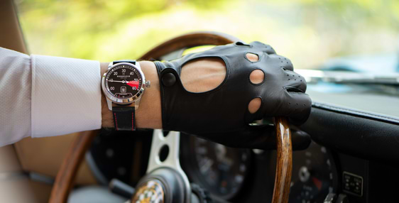 Vintage car with luxury watch and rpm counter in light beige, very dark grey and dark brown.