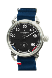 Black-dial wristwatch with white numerals, silver case, and a blue fabric strap with red-white detailing.