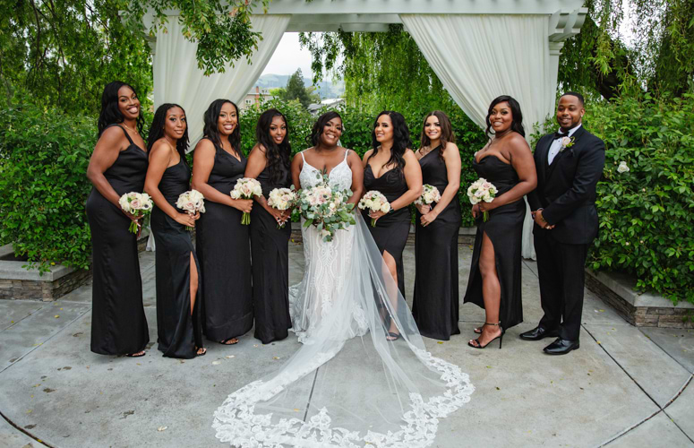 Bridal party posing after wedding ceremony is black dresses - San Ramon Waters by Wedgewood Weddings