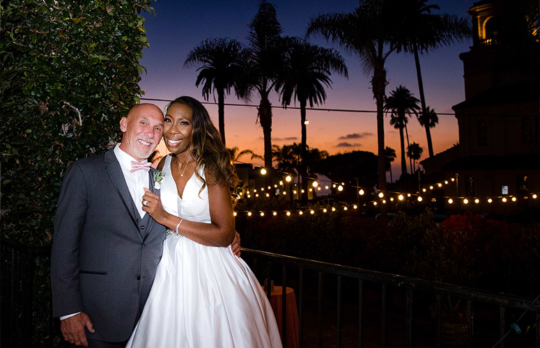 Bride-and-Groom-enjoy-sunset-backdrop-and-romantic-bistro-lights-in-courtyard-at-Cuvier-Club