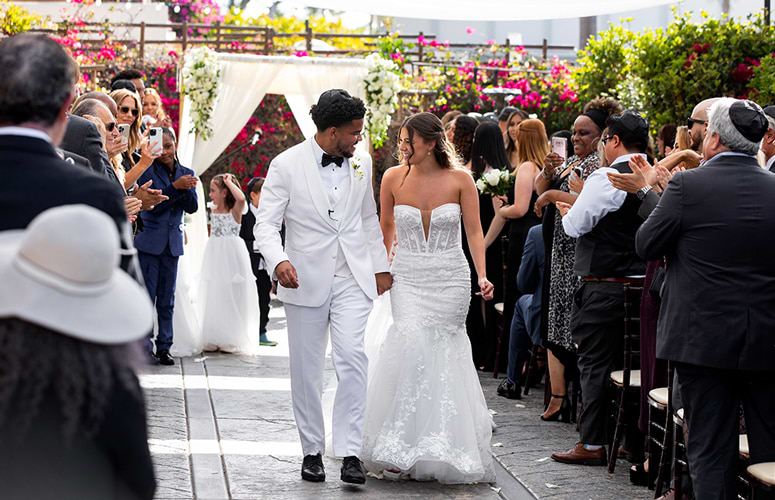 Bride-and-Groom-walk-down-the-aisle-at-courtyard-garden-ceremony-at-Cuvier-Club