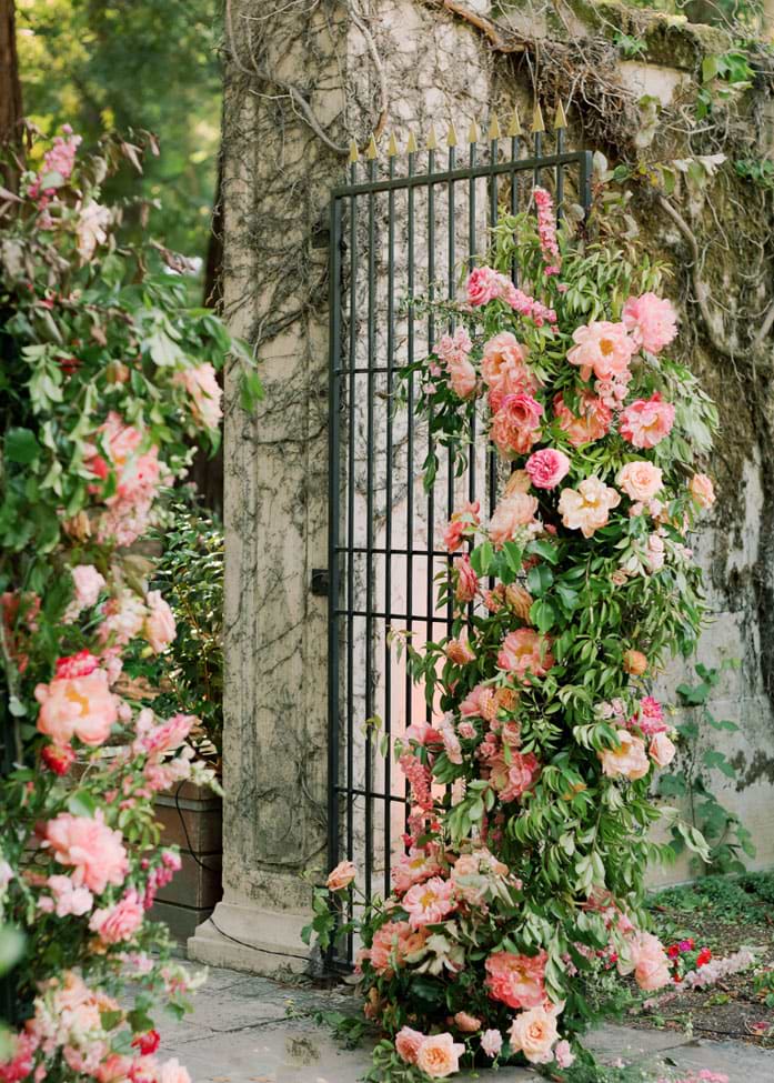 Floral arrangement decorating the iron garden gates 