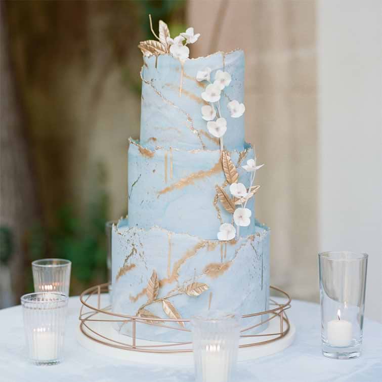 Beautiful blue cake with golden leave as accent decor 