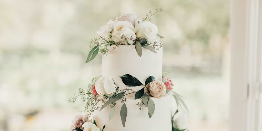 Attention to detail can mean flowers in all the right places like your cake, aisle, arch, and tables