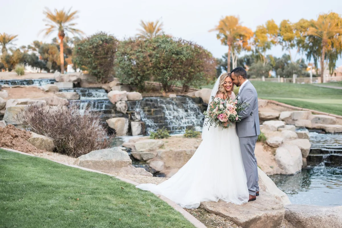 Newlyweds Pose By Waterfall at Ocotillo Oasis
