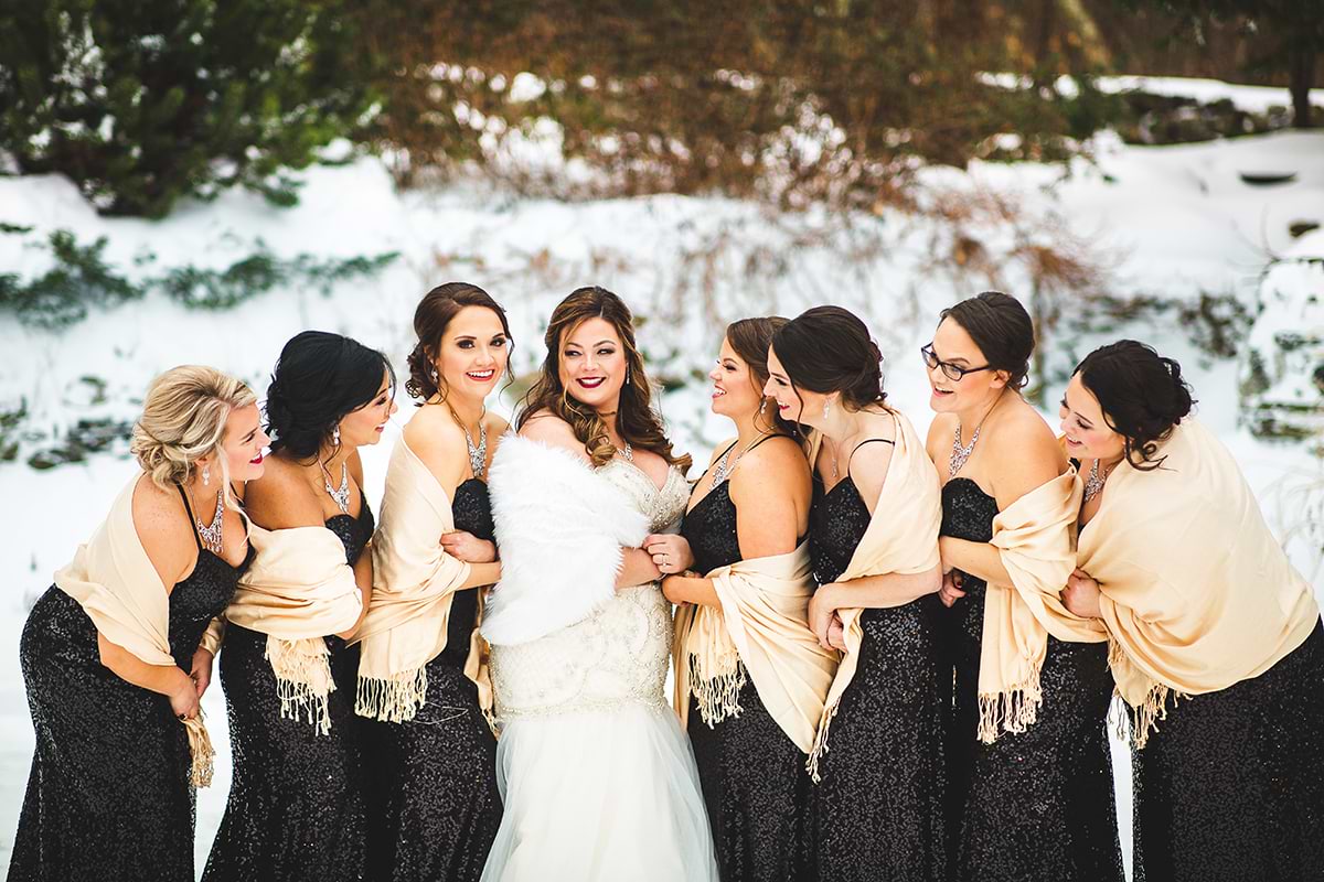 A bridal party in the snow during a winter New England wedding at Granite Rose