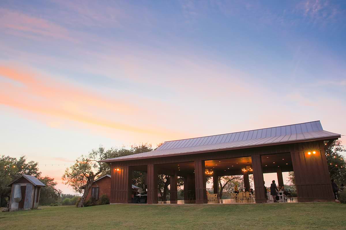 A sunset outdoor wedding in Texas at Hofmann Ranch