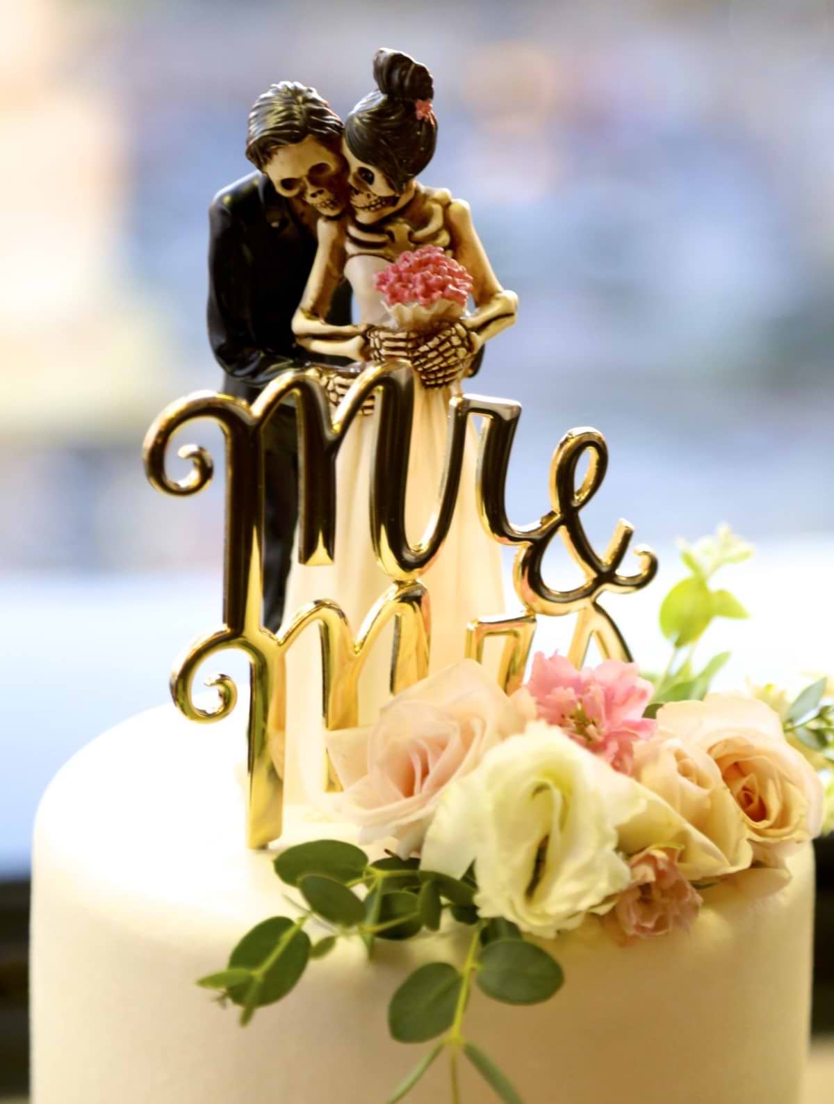 a Macabre skeleton bride and groom wedding cake topper