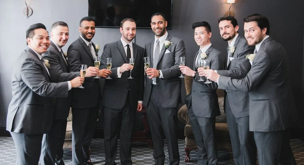 The groom's party celebrate with a champagne toast