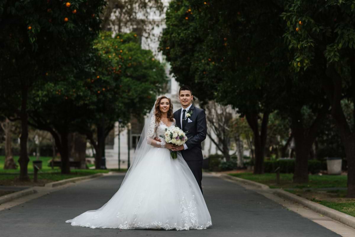 Newlyweds smile for a wedding portrait in Downtown Sacramento