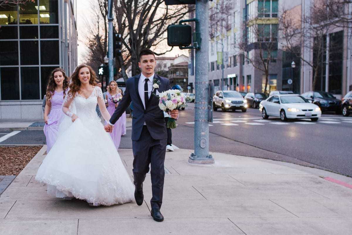 A bride and groom head to their Downtown Sacramento wedding venue at Sterling Hotel