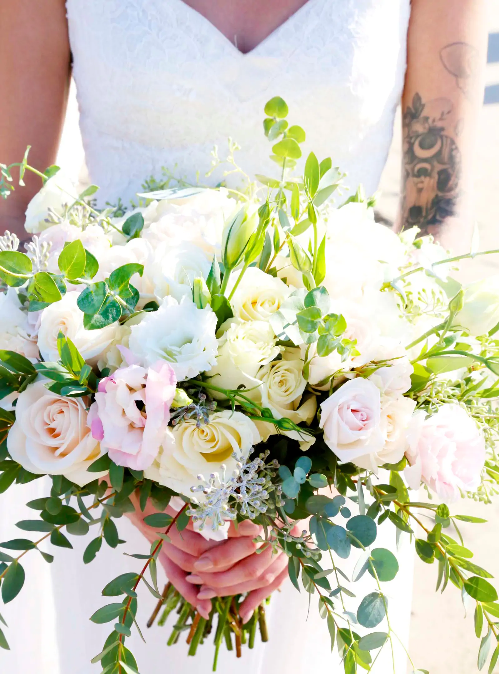 Lillian carried a lush bouquet of soft roses and bright greenery