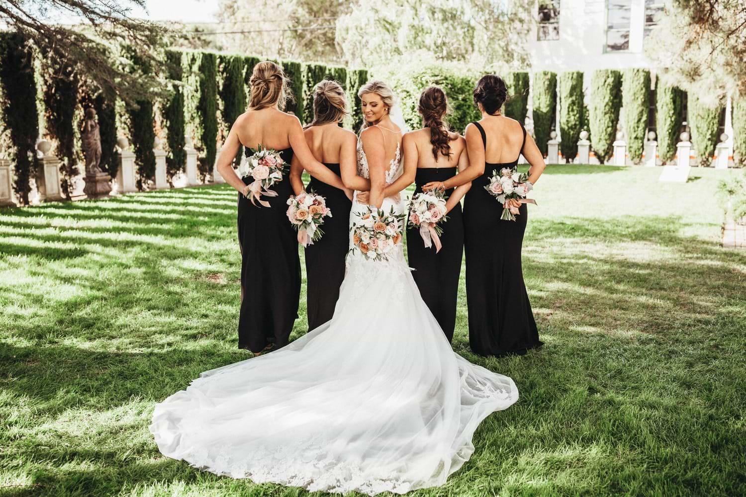 Bride and Bridesmaids Pose Outdoors