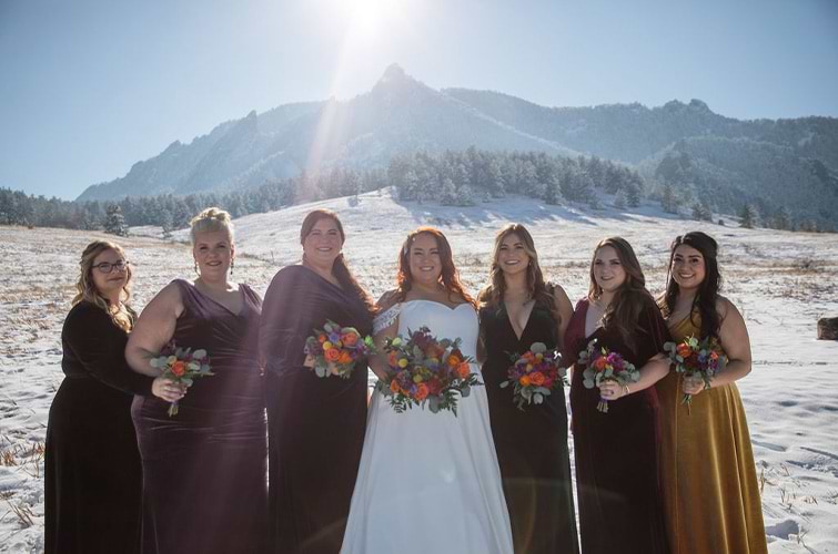 Bride and bridesmaids in velvet jewel tones against snowy mountains - Boulder Creek by Wedgewood Weddings