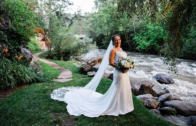 Bride posing by creek with long veil - Boulder Creek by Wedgewood Weddings