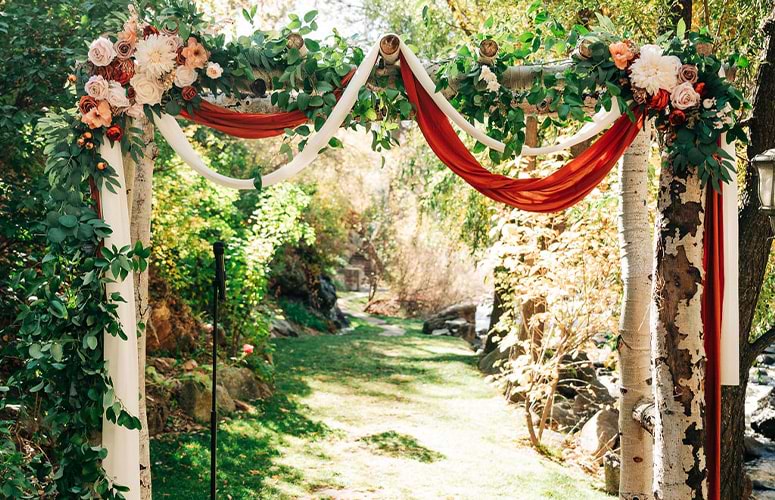 Closeup of arch with faux greenery & drapery - Boulder Creek by Wedgewood Weddings