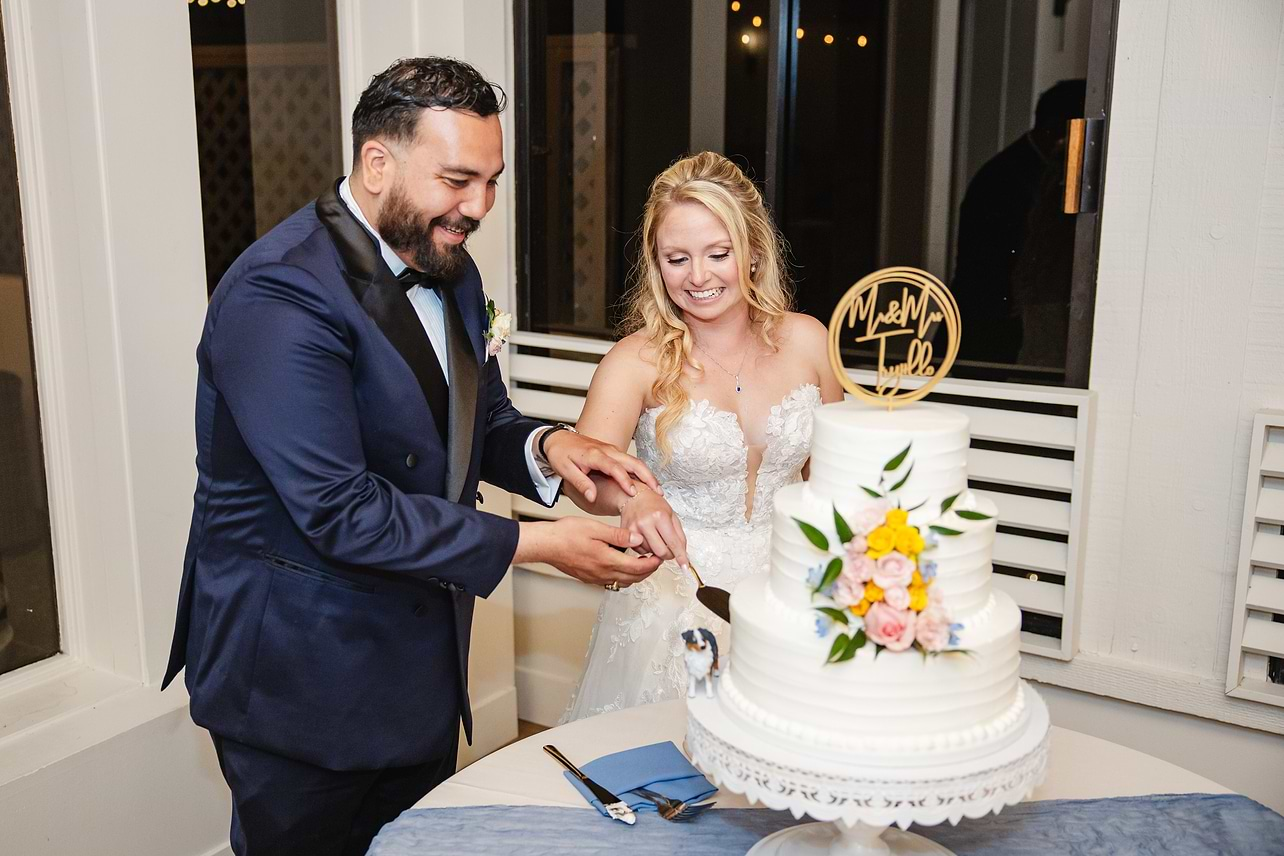 Couple during cake cutting at Carmel Fields by Wedgewood Weddings