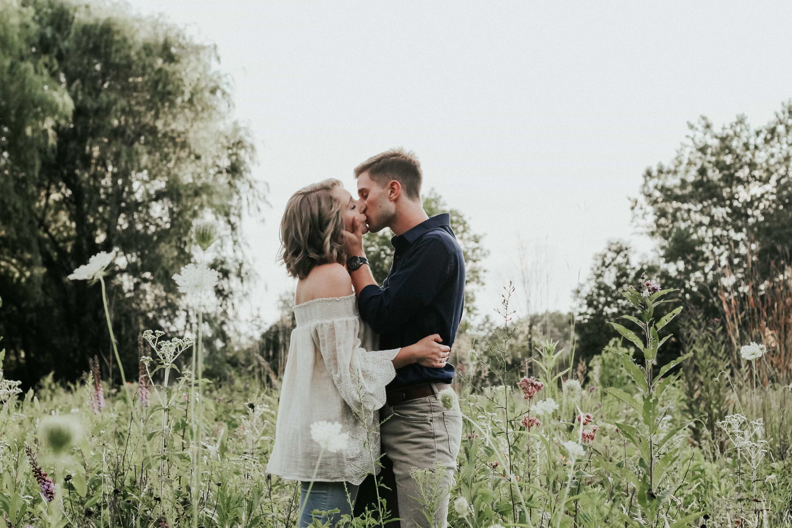 Couple kissing in meadow