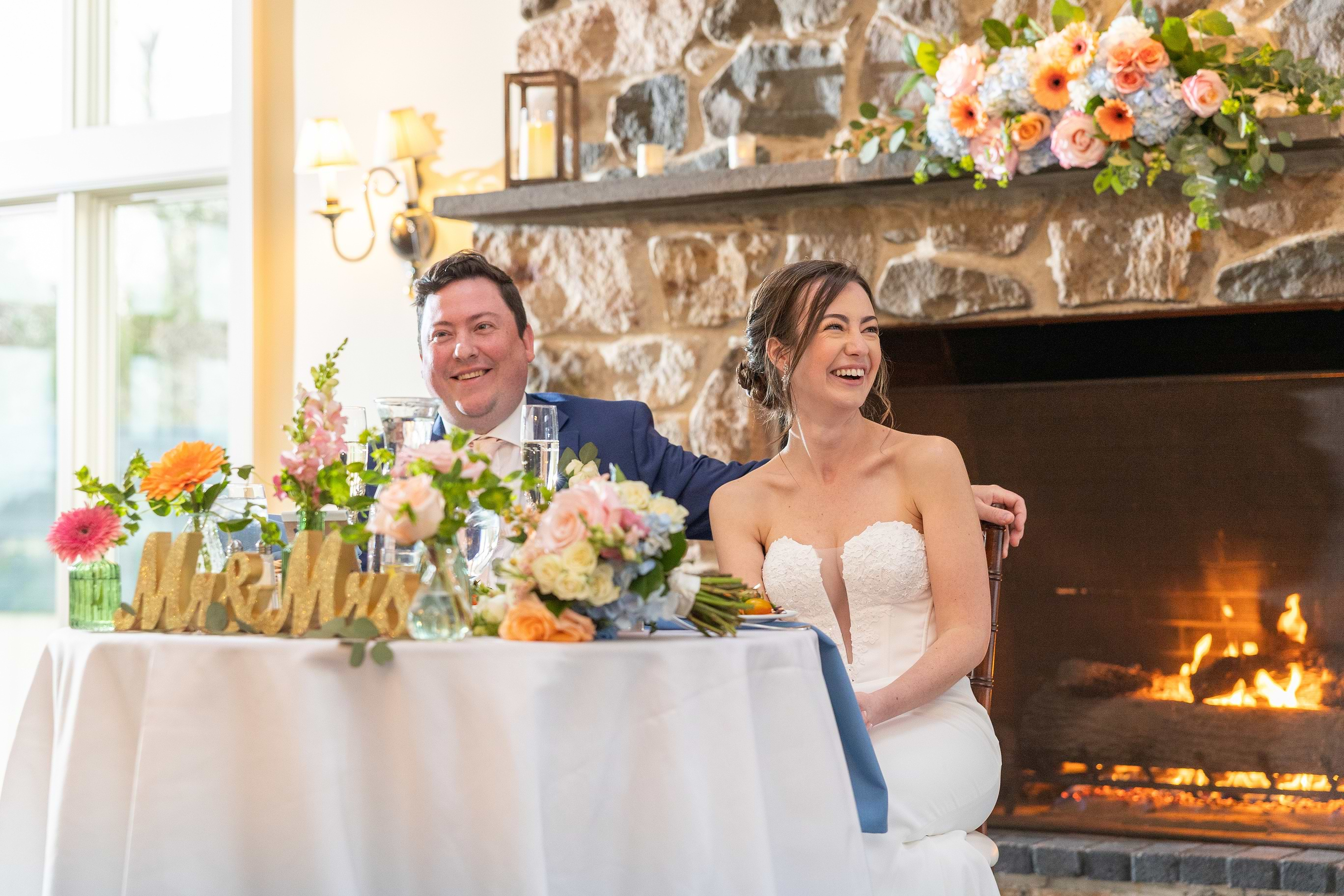 Couple laughing during toasts at Barker House by Wedgewood Weddings