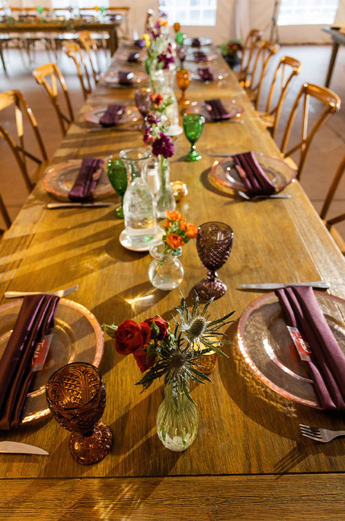Farm table with rented glassware, chargers, & jewel tone colors - Boulder Creek by Wedgewood Weddings