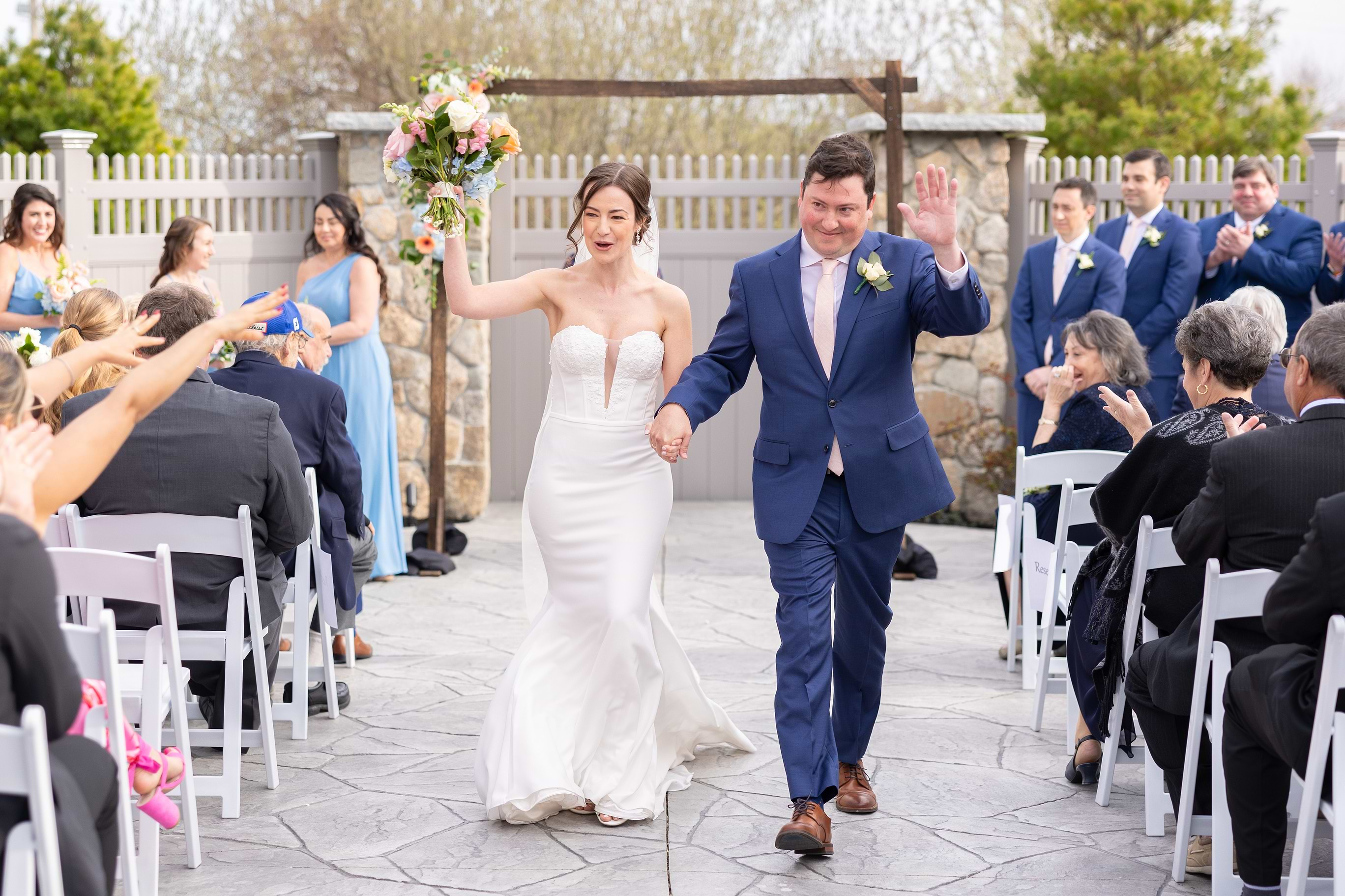 Newlyweds during their recessional at Barker House by Wedgewood Weddings