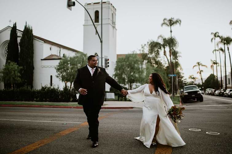 Newlyweds strolling across the street in Fillmore, CA