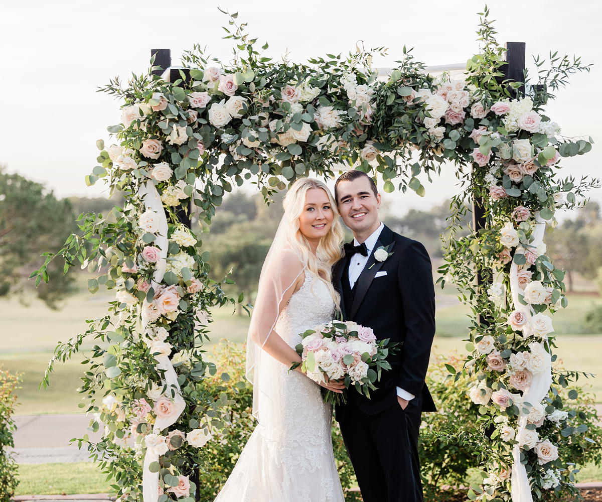 Couple by arbor lawn with arch flowers - Aliso Viejo by Wedgewood Weddings