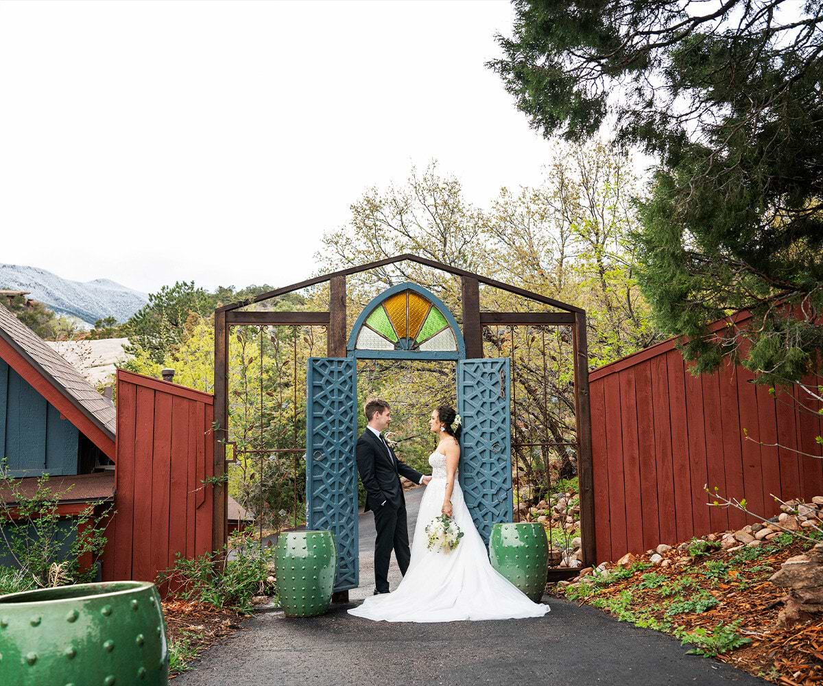 Couple posing in front of charming doors - Craftwood Peak by Wedgewood Weddingshttps://www.wedgewoodweddings.com/craftwoodpeak