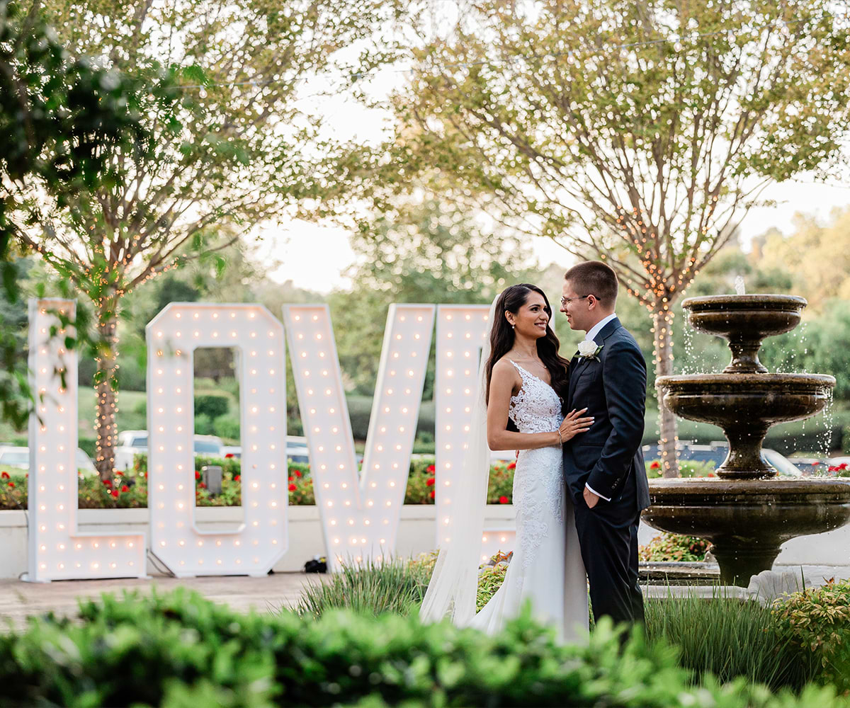 Couple by fountain at Fallbrook Estate by Wedgewood Weddings