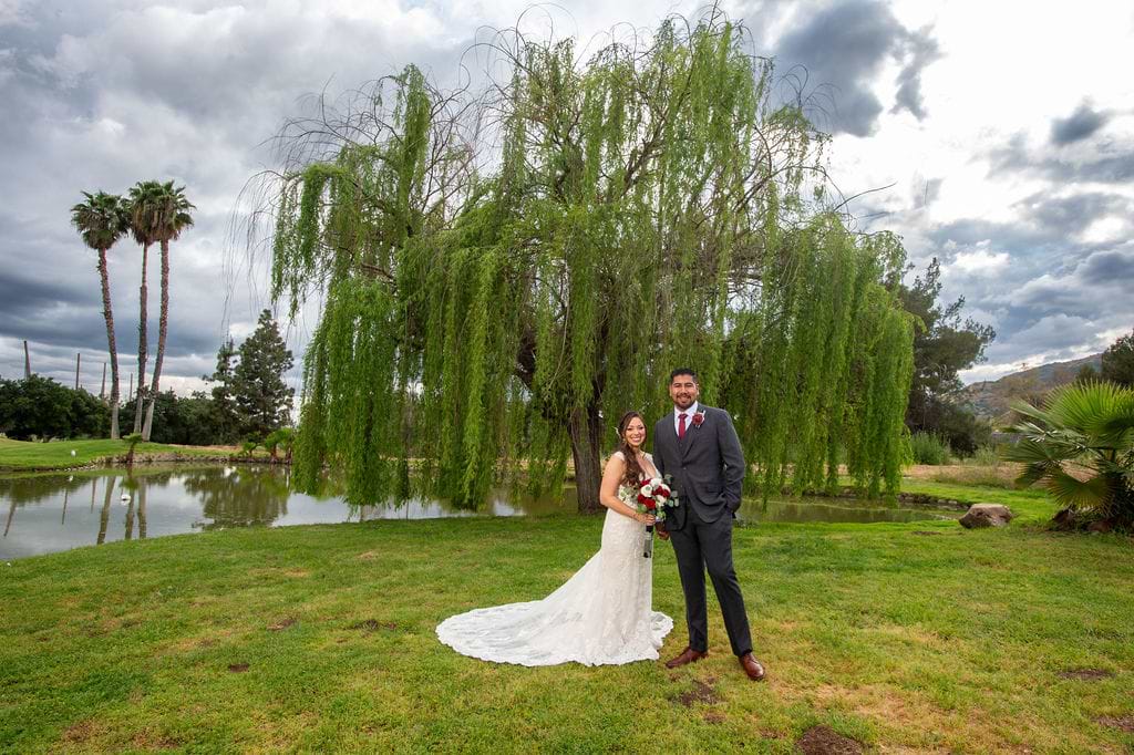 Angela and Cesar by the willow tree