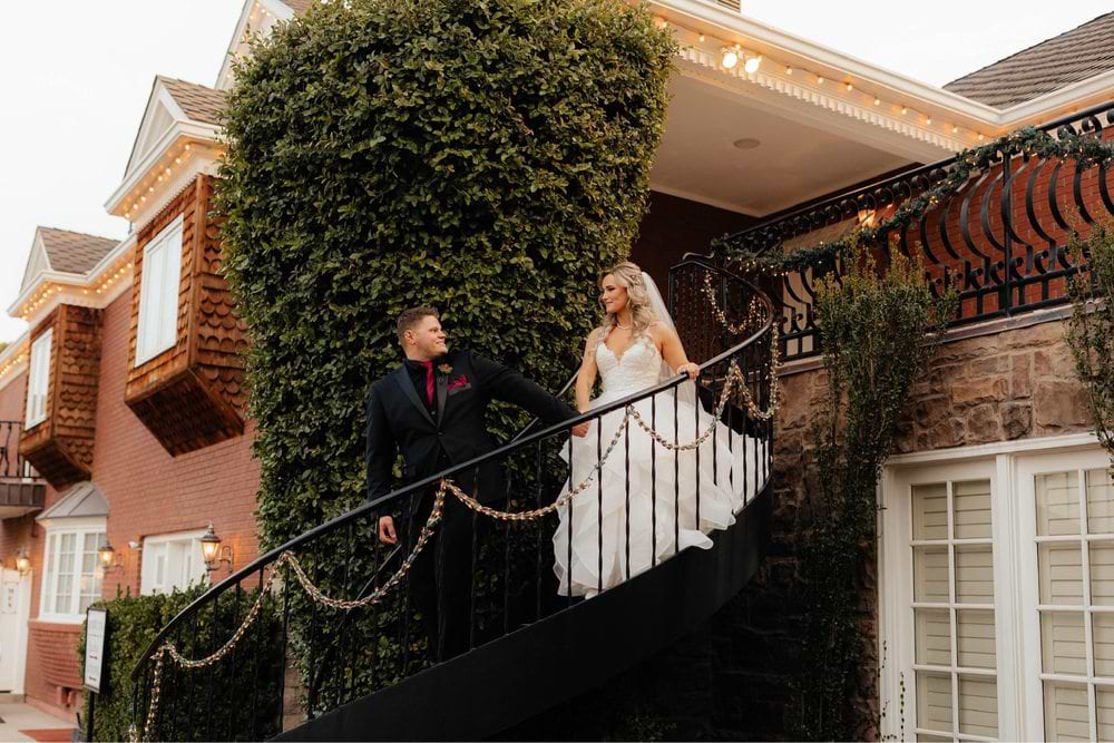 Katie & Shad on the spiral staircase at Stonebridge Manor