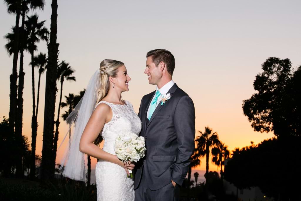 outdoor beach wedding with palm trees at sunset