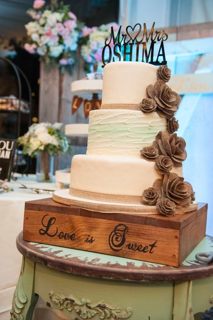 rustic wedding cake stacked on rustic wood platform