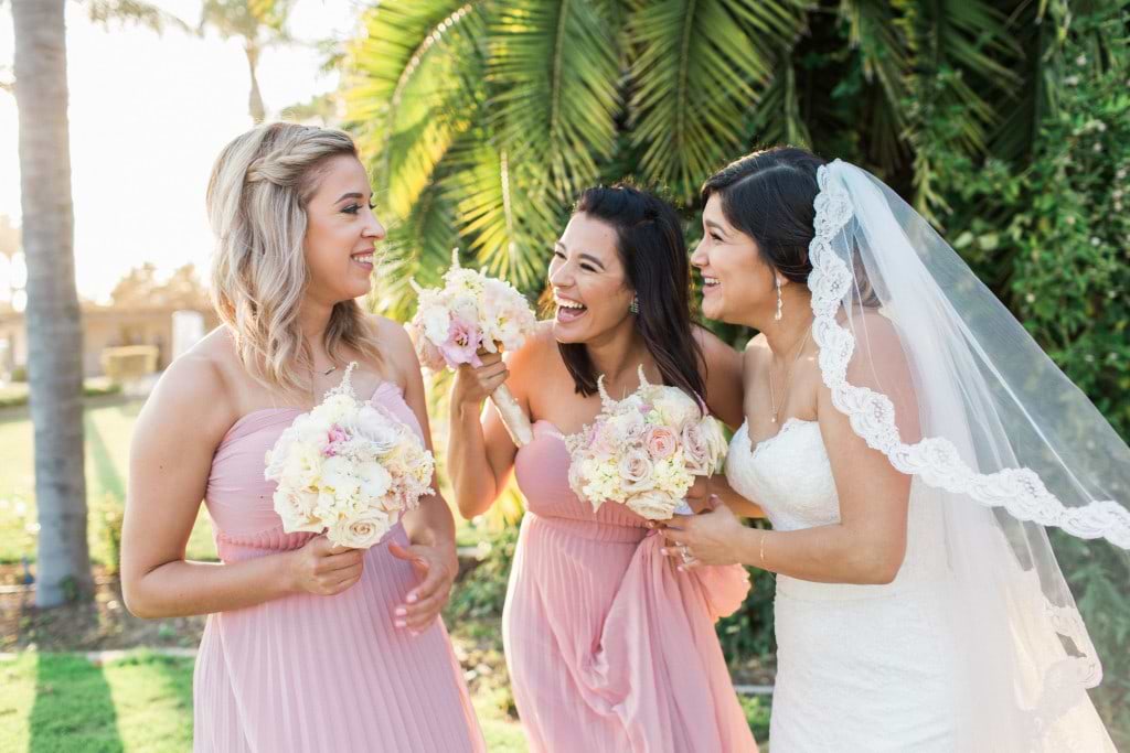 bride laughing with bridesmaids at bridal party