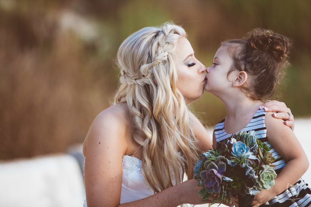 Wedgewood Weddings bride kissing a Flower Girl