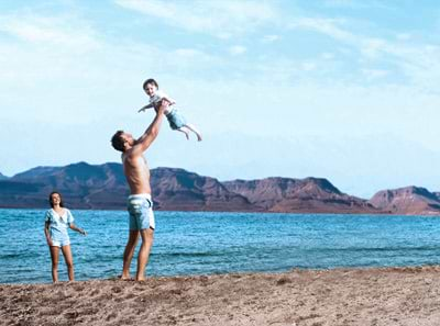 A father and his children at the beach in Tel Aviv