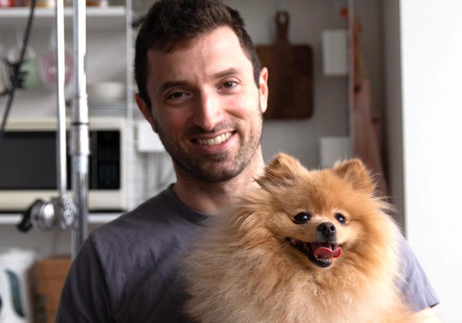  a man holding a small dog in his arms 