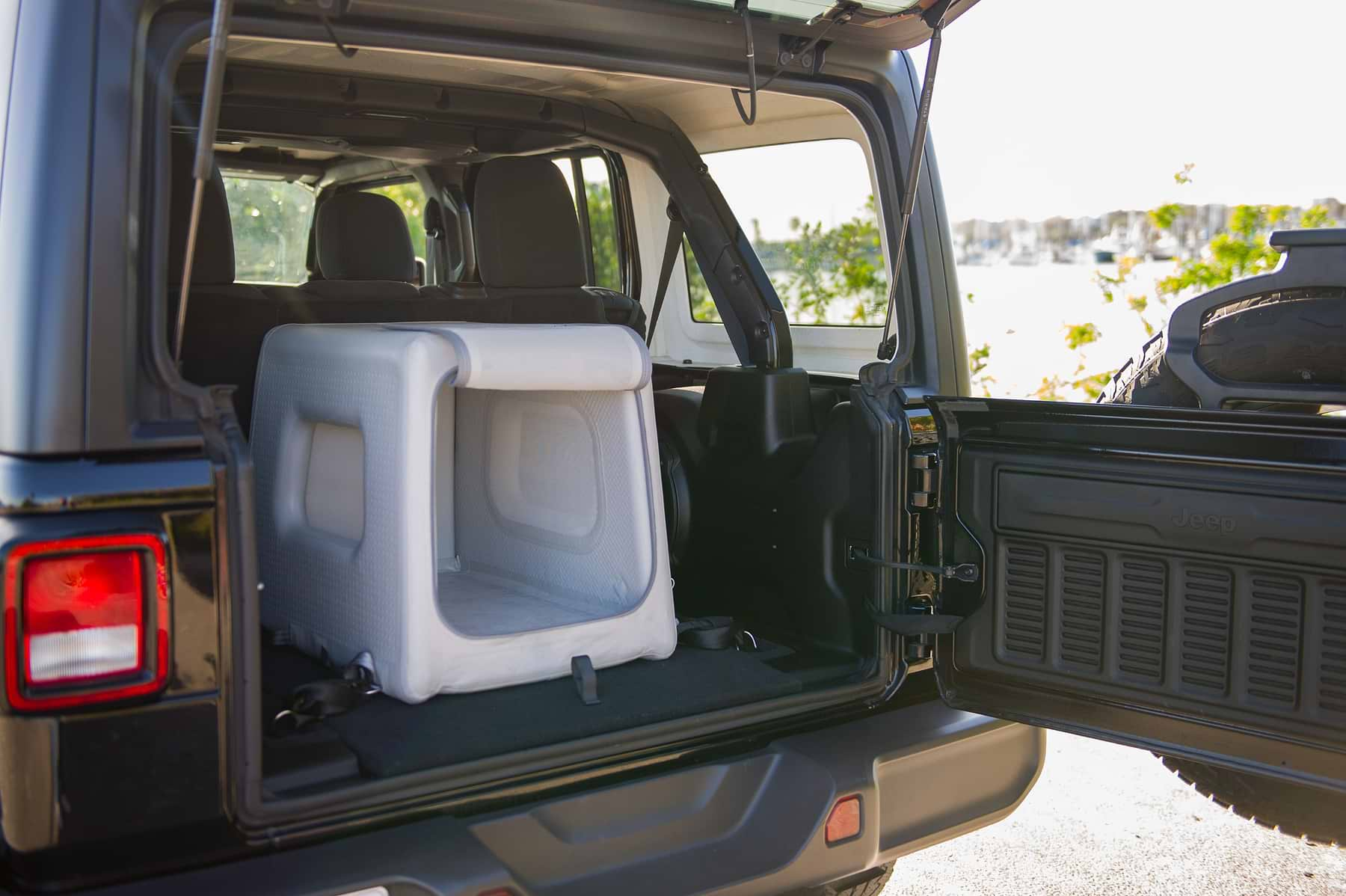  the open trunk of a black car with an Enventur in it 