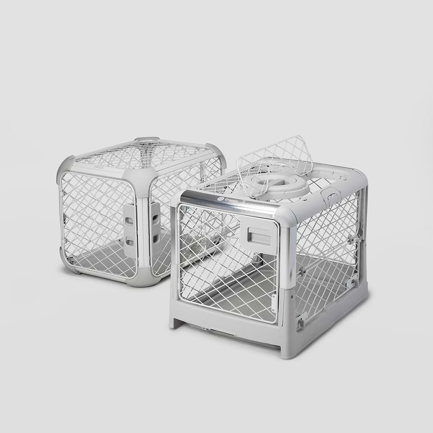 A Revol and an Evolv dog crate sitting next to each other