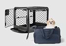 A small dog sitting in a Passenger pet carrier bag next to a dog crate