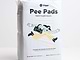  a bag of pee pads sitting on top of a white table 