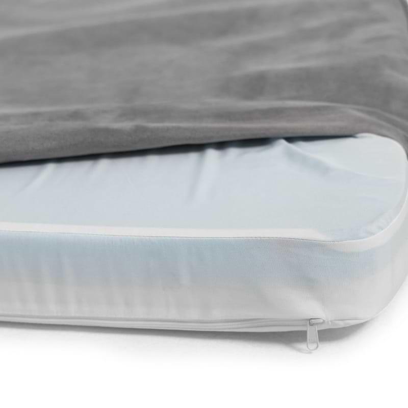  a close up of a grey snooz pad with the outer cover partially removed 