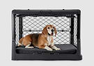 A dog laying on top of a dog crate