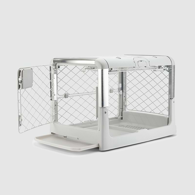 A white dog kennel with the door open