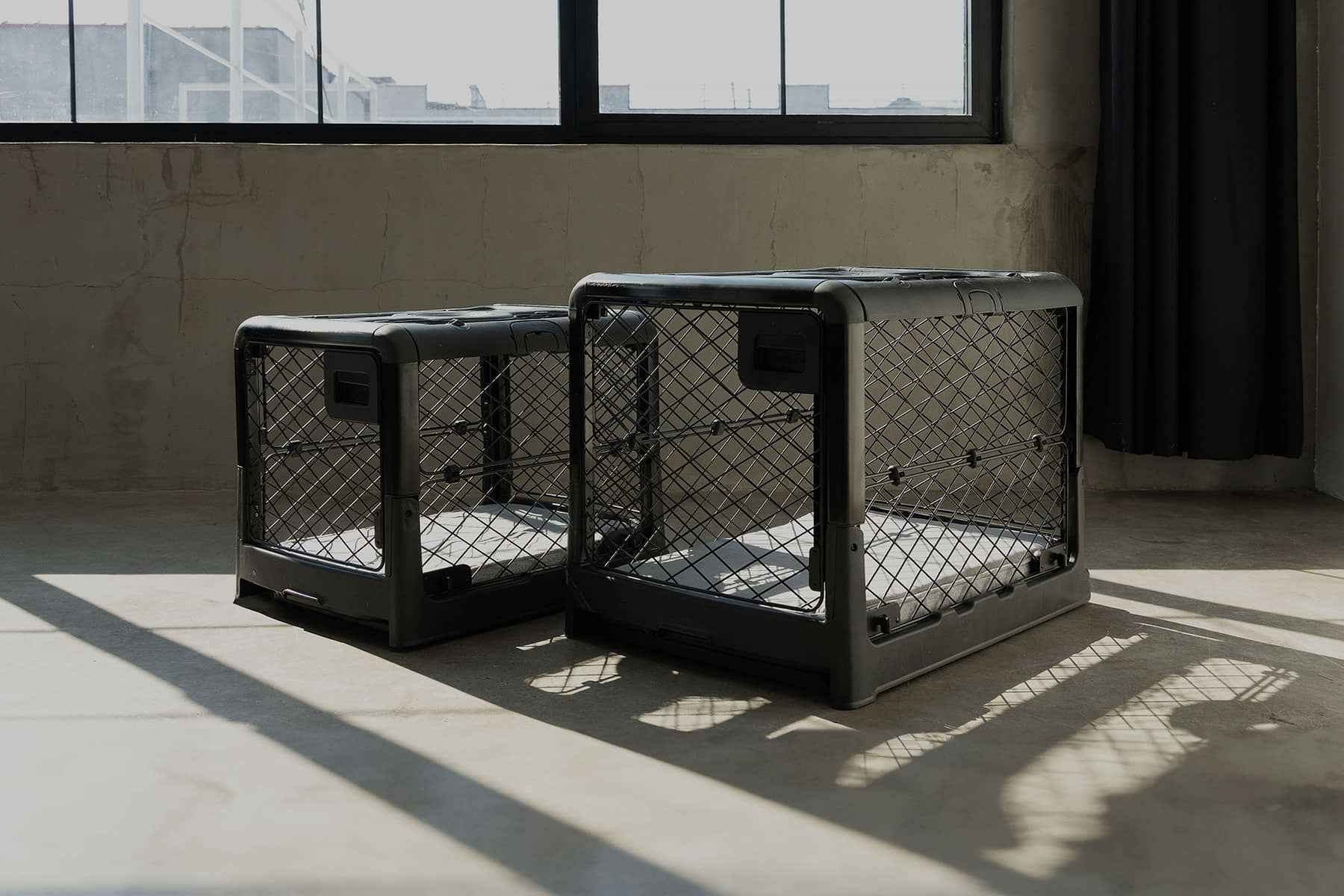  Two black Revol crates in a warehouse 